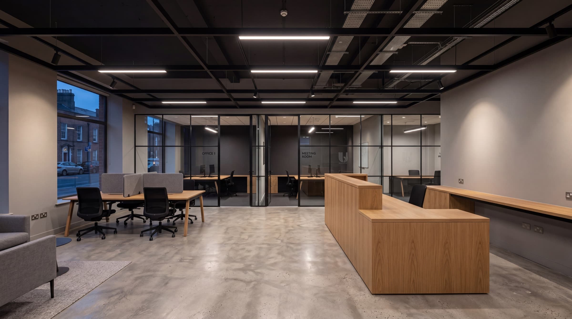 Modern Irish commercial office or retail unit interior with exposed ceiling grid, integrated LED panel lighting, and polished concrete floor