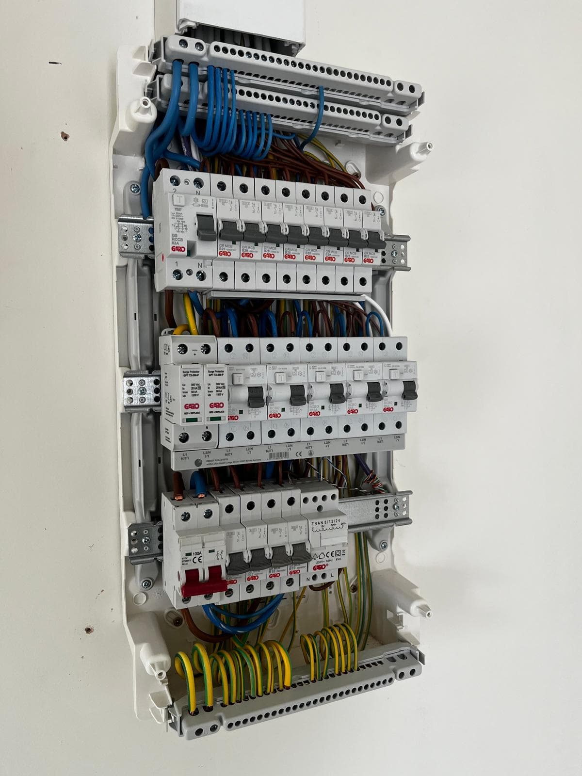 Completed consumer unit with neatly terminated colour-coded wiring and clearly labelled circuits